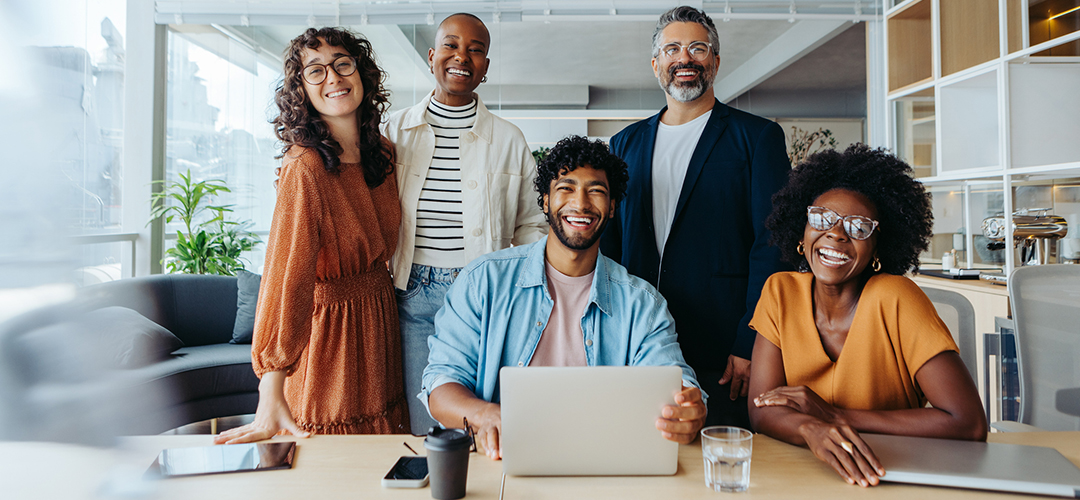 Successful team of business people smiling at the camera in a startup office lca roles